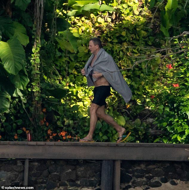 Daniel Craig dries after filming scenes of Bond 25