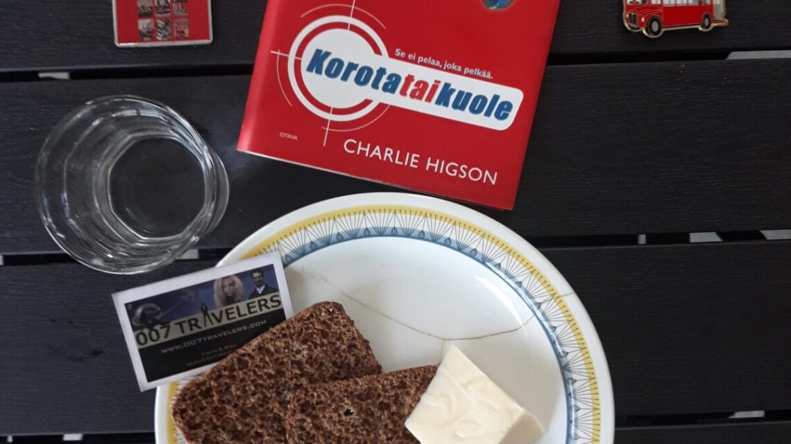 007 Food: Chipped plate with a wedge of pork pie, two slices of hard, dry bread and a lump of stale cheese on it